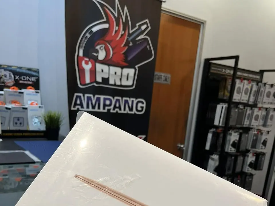 Sealed MacBook Air box held at the iPRO Ampang counter, shop banner behind